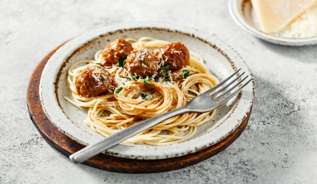 spaghetti with meatballs on rustic plate