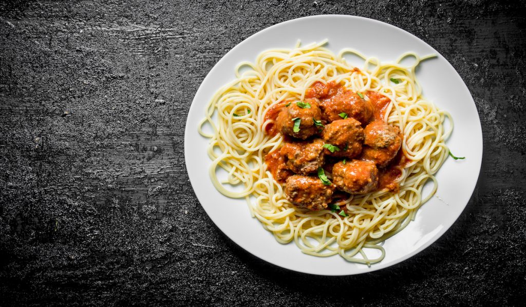 spaghetti with meatballs sauce on white plate