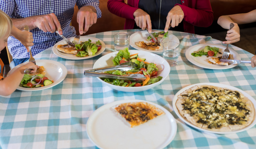 Family eating pizza and salad together