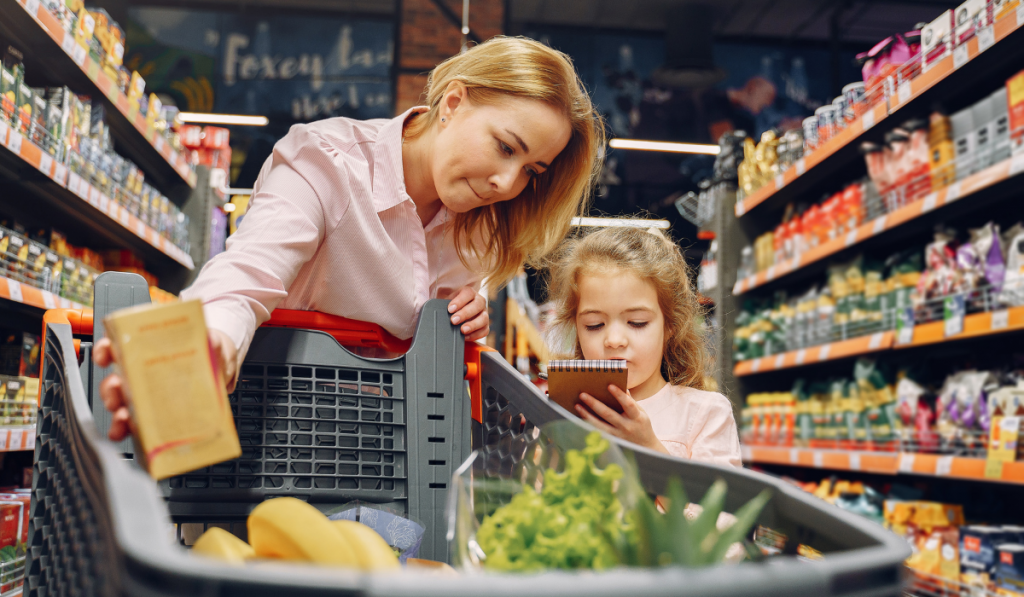 Mom and daughter buys groceries at the supermarket, daughter checks on the list
