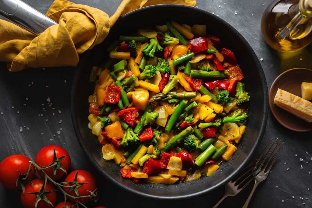 fried vegetables with sauce on a pan
