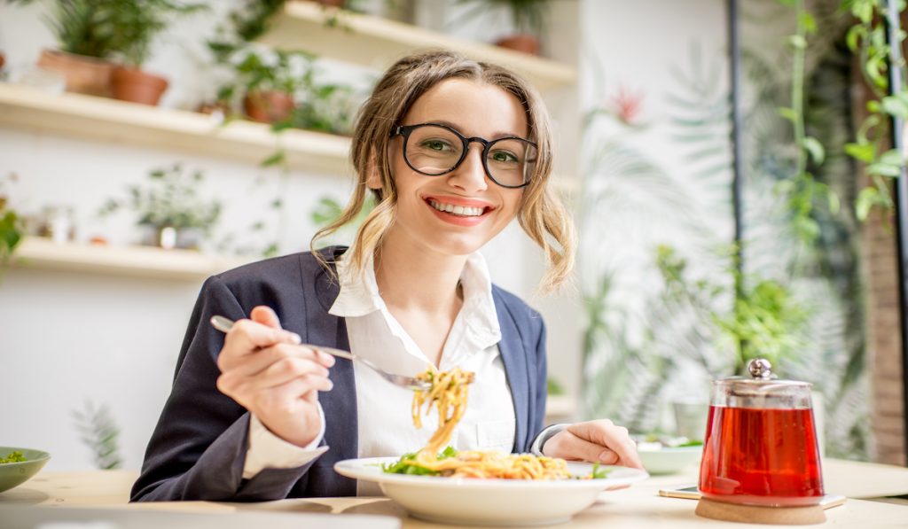 woman eating pasta at the restaurant